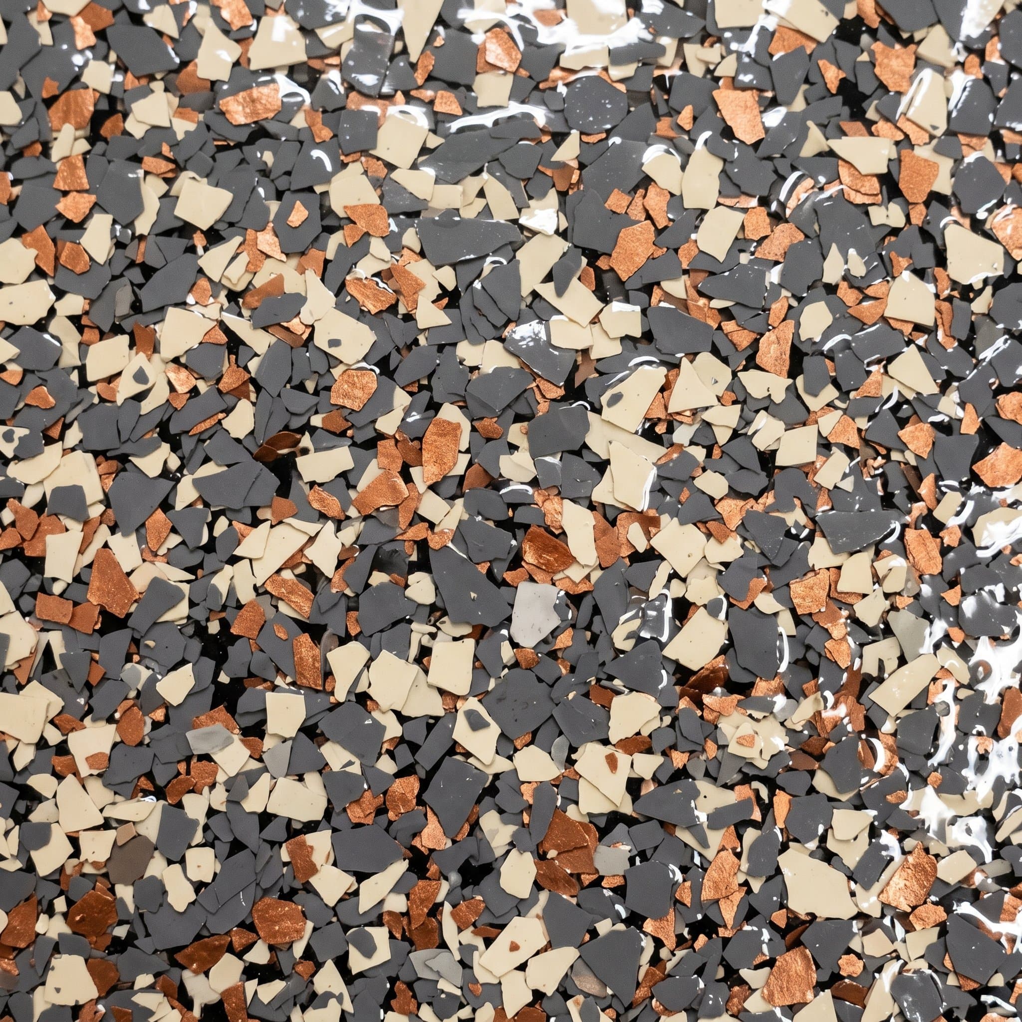 Cured floor with cream, copper, slate flakes under topcoat.