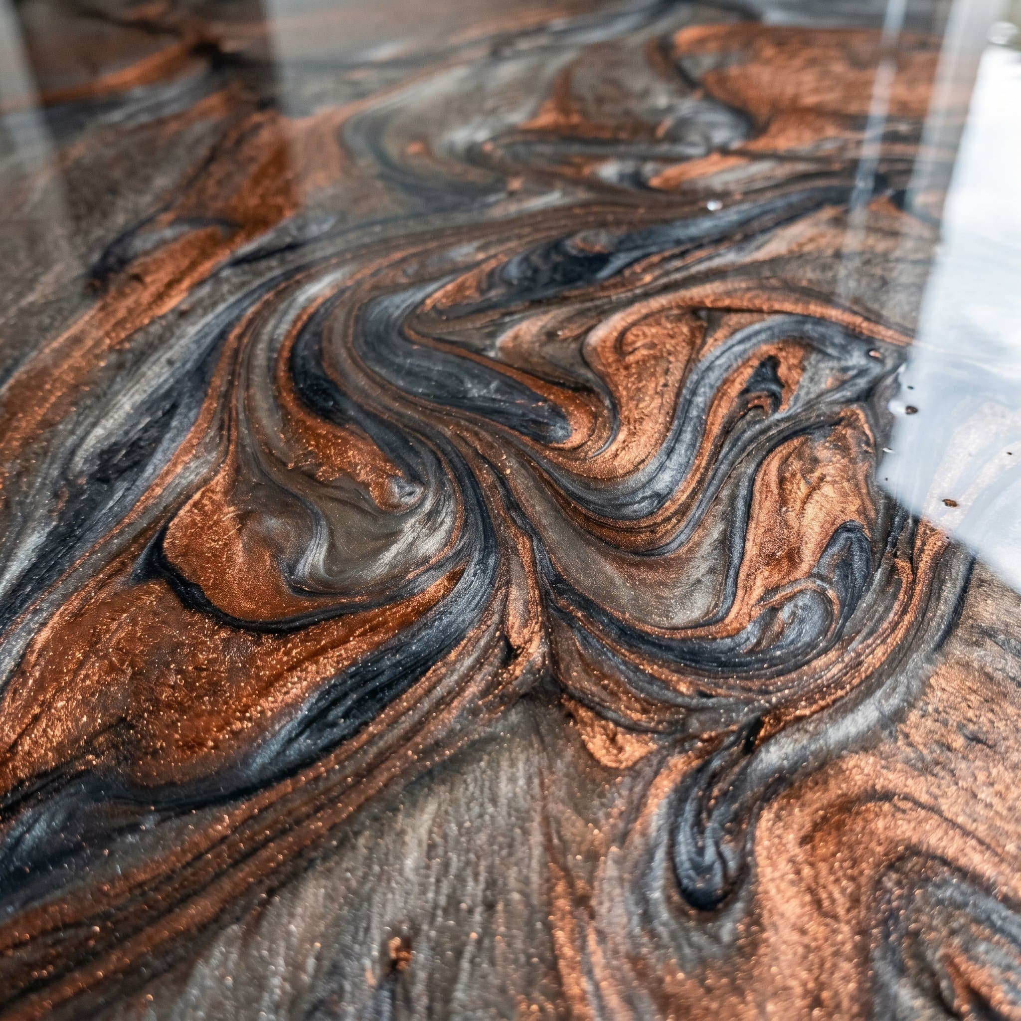 Cured metallic epoxy with mica swirls in copper, slate.
